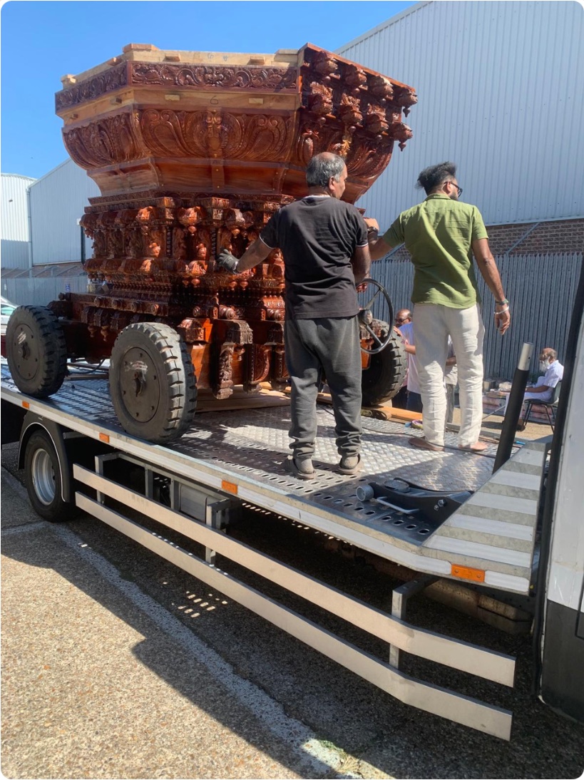 Carved ceremonial structure transported on a flatbed vehicle in South West London